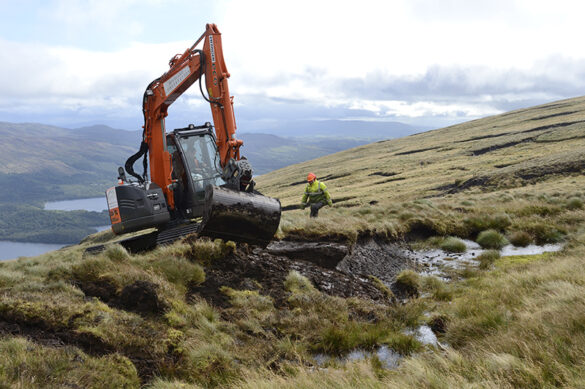 Excavator carrying out peatland restoration work